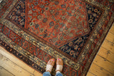 Antique Malayer rug with refined herati motifs, saturated terra cotta, and indigo borders.