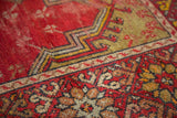 Vintage Mudjur rug's cherry red floral border and sage geometric mehrab motif.