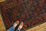 Antique Belouch rug: geometric lattice, terra cotta, charcoal, thick meandering border, original selvage.