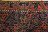 Antique Belouch rug's geometric main border, lattice field, terra cotta rust and etched browns.