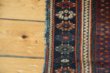 Partially secure side of antique Persian Jaff Kurd rug showcasing hook and latch border.