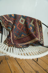 Light tatter on the end of an antique Jaff Kurd rug, with red and indigo geometric motifs.