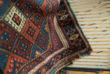 Antique Jaff Kurd rug edge with light tatter, geometric gul, and hook and latch motifs.