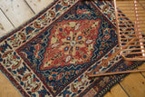 Antique West Persian rug mat showing the central floral medallion and intricate border design.