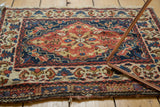 Corner view of an antique Persian bag face showing its intact side cord selvage and floral border.