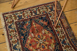 Corner detail of a collector's antique Persian bag face with expressive vinery and original side cord selvage.