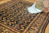 Vintage Malayer rug's intricate herati motif with animals, dark indigo, and earthy tones.