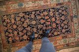 Vintage Kurdish rug with dark indigo field and vibrant Herati motif interpretations.