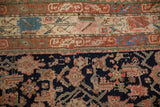 Detailed view of vintage Kurdish rug's Herati-like motifs and borders in indigo, blush, and terracotta.
