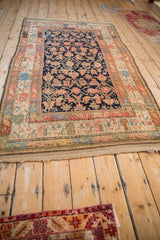 Original macrame fringe and time-softened multi-banded borders of a vintage Kurdish rug.