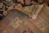 Close-up of vintage Kurdish rug fold, showing colorful pile and hand-knotted foundation weave.