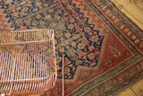 Vintage Malayer rug showing intricate indigo herati motif against a blush red border.