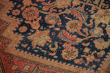 Textured pile and worn herati motif, with serrated border, on a vintage Malayer rug.