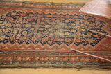 Vintage Malayer rug border detail with stylized figures, indigo, and blush red tones.