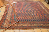 Antique Persian Malayer rug: repeating boteh field, Mir Serbend border in dark indigo, rust, ivory.