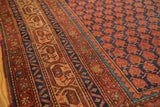 Antique Malayer rug: rust boteh field, indigo Mir Serbend border, antique ivory, copper green.