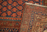Antique hand-knotted Malayer rug pile with rust boteh motifs and its visible woven foundation.