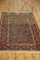 Antique Belouch rug's scrolling terra cotta and dark brown border, with geometric field and chevron kilim.