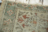 Worn beige and peach Oushak rug corner, secure selvage, fringe, exposed foundation.
