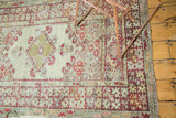 Vintage Anatolian rug, cherry red splayed floral main border, worn ivory field.