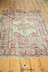 Cherry red and ivory diamond medallion, floral border, and exposed foundation.