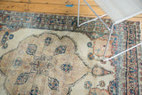 Soft palette of aged blues and cochineal reds in the Kerman rug's corner spandrel design.