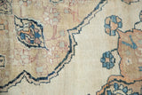 Antique Kerman rug with delicate floral blossoms in blue, red, and foundation wear.