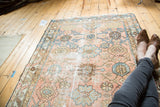 Vintage Lilihan rug field with primitive stylized floral vinery in pale blush and sky blue.