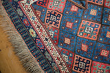 Antique Jaff Kurd rug corner with sapphire blue geometric field, intricate gem-tone borders, and fringe.