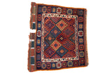Antique Jaff Kurd bag face with a geometric lattice design in saturated gem tones of blue, red, and green.