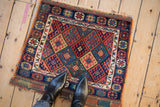 An overhead view of an antique Jaff Kurd bag face, highlighting its scale and colorful lattice design.