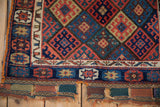 Close-up of the flatwoven end and geometric wool pile of an antique Jaff Kurd bag face.