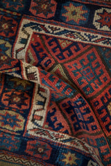 Richly saturated gem tones in the dense hand-knotted wool pile of a Kurdish bag face.
