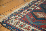 Antique Jaff Kurd rug corner, tattered fringe, reduced side, and indigo geometric designs.
