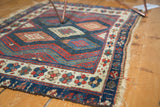 Jaff Kurd rug's ivory border with clustered floral motifs, indigo bands, and tattered end.