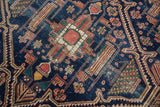 Antique Malayer rug detail: intricate rectilinear patterns with serrated indigo, terra cotta, ivory, and green.
