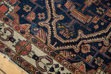 Antique Malayer rug detail: indigo, ivory, terra cotta serrated patterns and edge tatter.