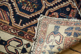 Antique Malayer rug's indigo and ivory rectilinear pattern with woven reverse and edge tatter.