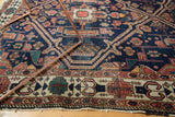Fine serrated rectilinear patterns and ivory border on antique Malayer rug, with indigo and green hues.