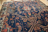 Antique Malayer rug, intricate rectilinear pattern, indigo, terra cotta, ivory, with wear.