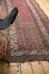 Vintage Hamadan runner with repeating madder red boteh motifs, ornate borders, and even wear.