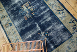 Detail of antique Peking rug highlighting even wear, cobalt blue field, and fruit border.