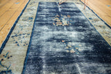 Antique Peking rug: Hard wear revealing white foundation on deep cobalt field with faded floral motifs.
