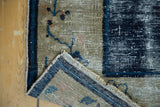 Antique Peking rug: Hard wear revealing foundation on ivory field, with blue selvage.