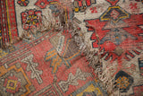 Hand-knotted antique Malayer rug edge with significant wear, visible foundation, and intricate floral details.