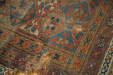 Close-up of tattered edge and holes on a late 19th century Kurdish geometric rug.