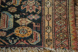 Antique Malayer rug detail: stylized animal figure on navy, geometric border, and tattered fringe.