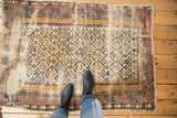 Antique Caucasian Shirvan rug with Marsali lattice design, showing tattered condition and visible foundation.