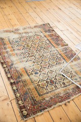 Antique Shirvan rug fragment corner, featuring geometric border patterns and exposed foundation.