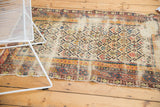 Hard-worn antique Caucasian Shirvan fragment featuring Marsali lattice and exposed foundation.